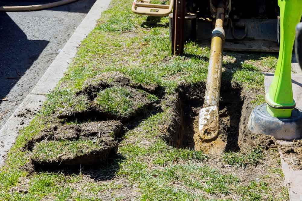 technicians preparing trenchless sewer repair equipment