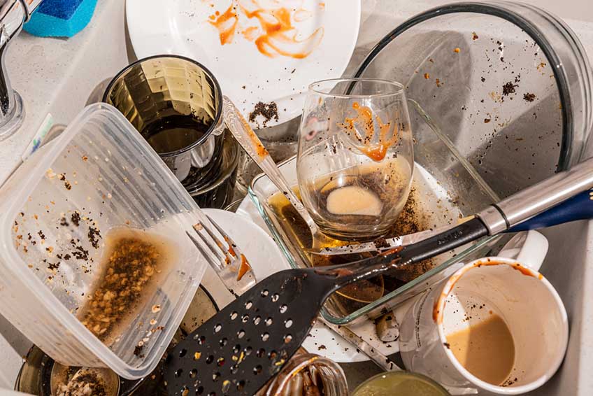 greasy pan and plates on the sink