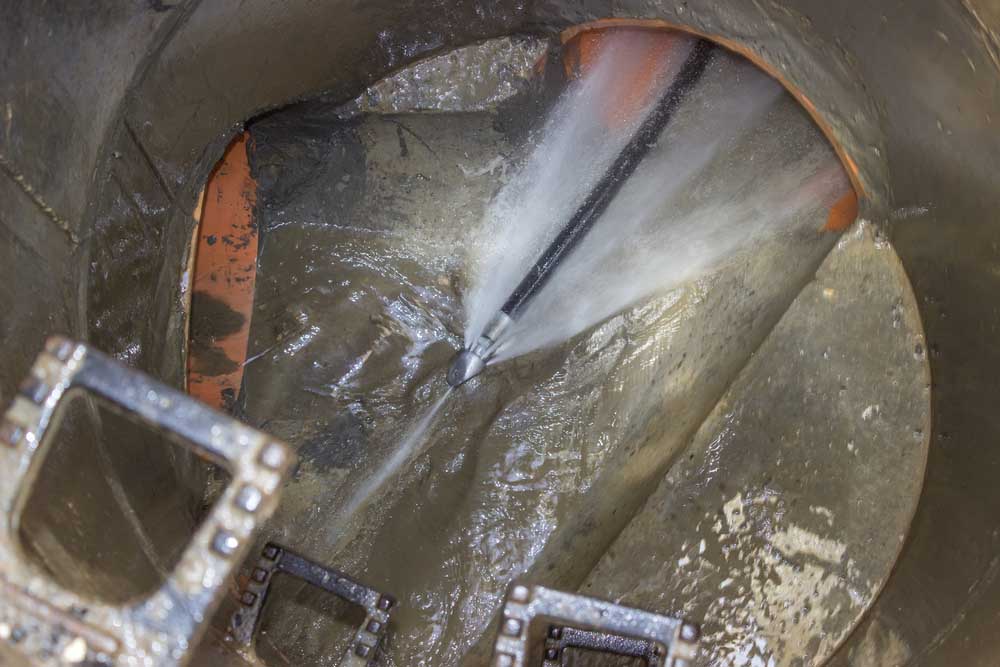 high-pressure water streams from hydro jetting equipment