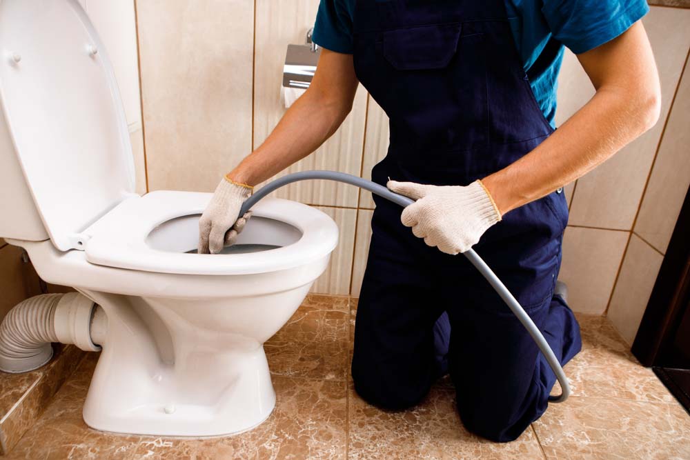 technician hydro-jetting a drain