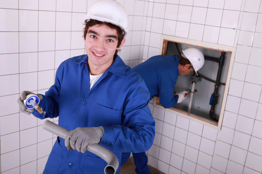 a person fixing a leaky pipe