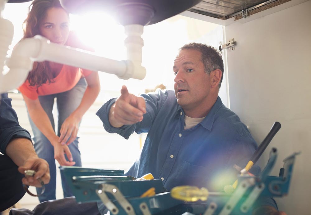 homeowner talking to a plumber Cape Coral, FL