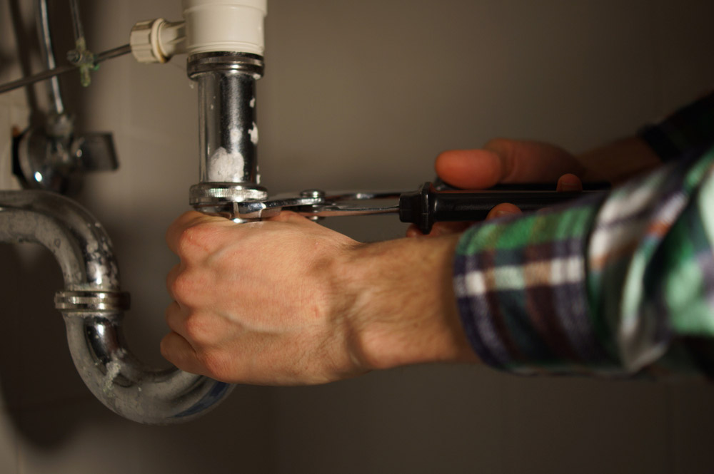 Plumber inspecting leaky pipe lines Cape Coral, FL
