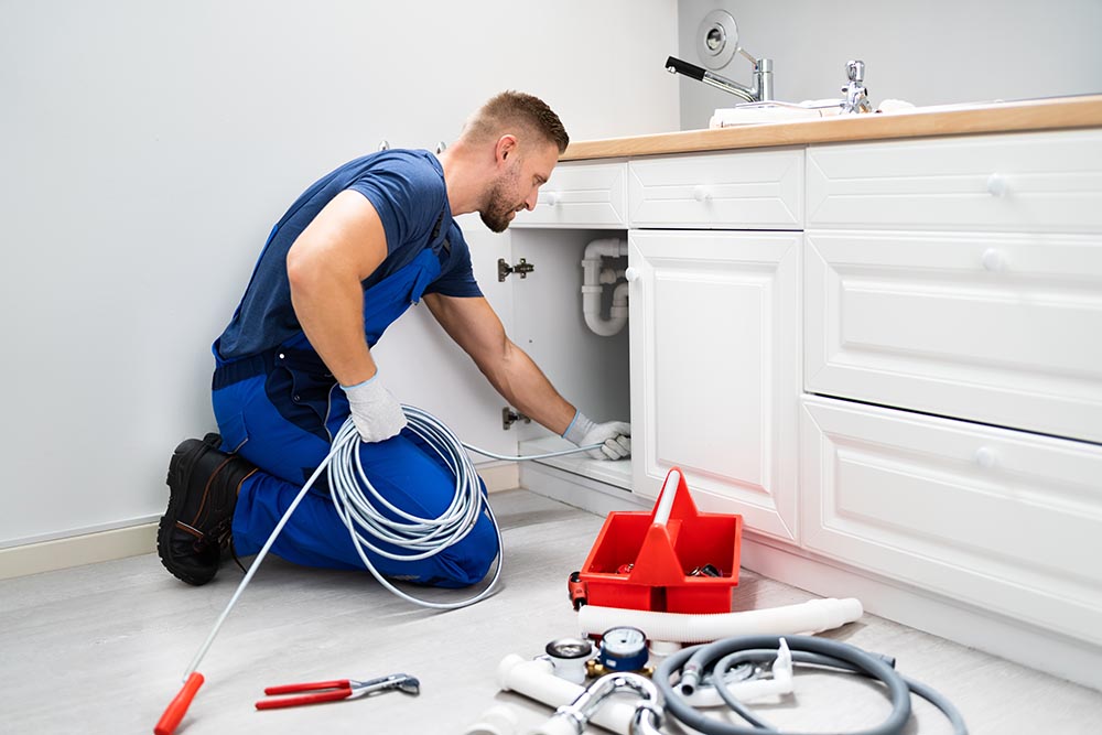 technician hydro jetting a drain