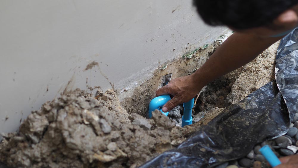 plumber fixing a leaky pipe